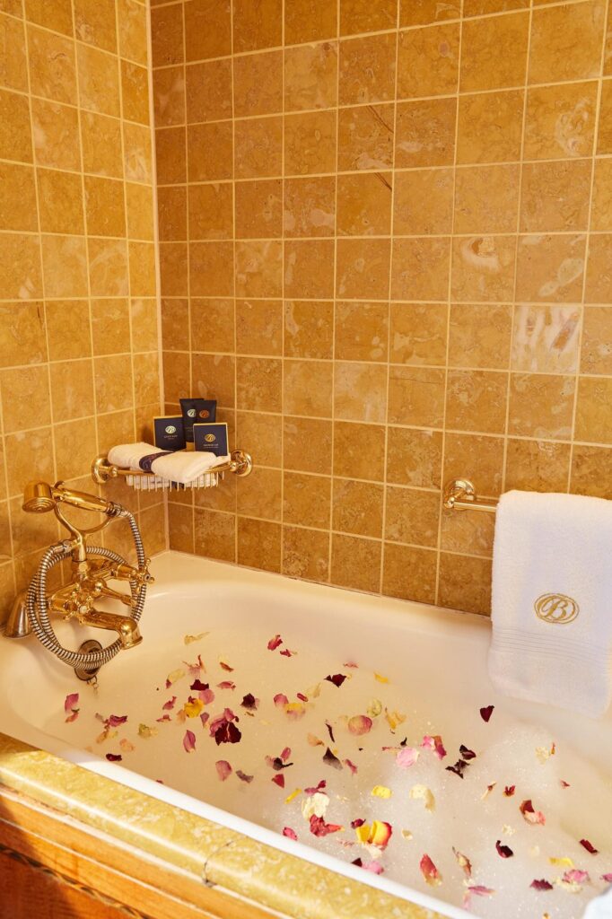 A suite bath drawn with rose petals