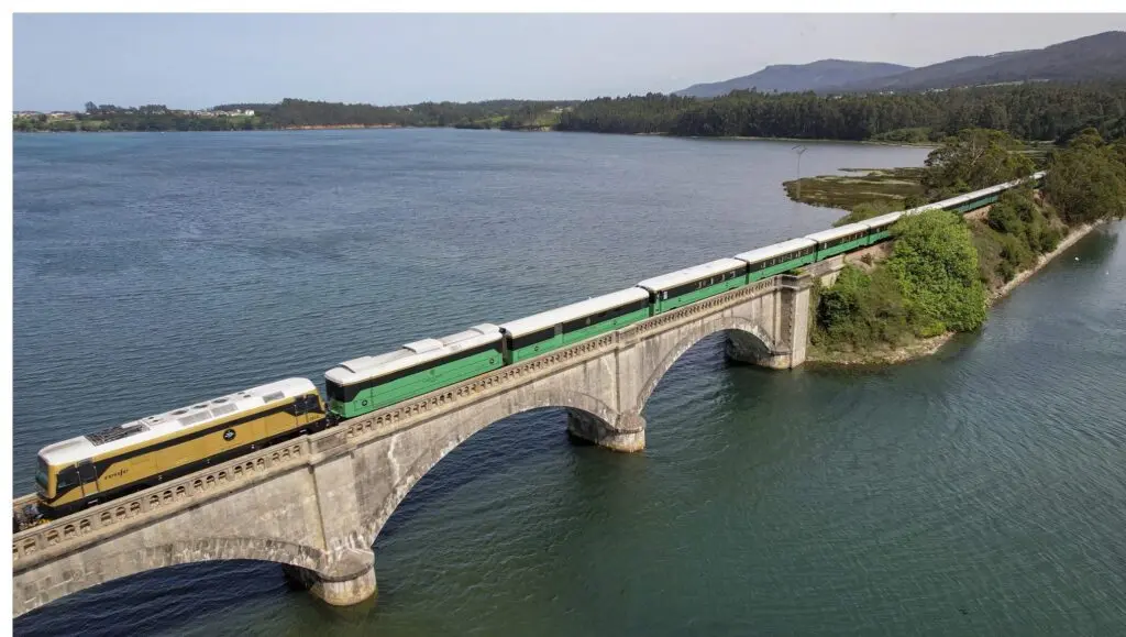 The Costa Verde Express crossing a stone viaduct over an estuary