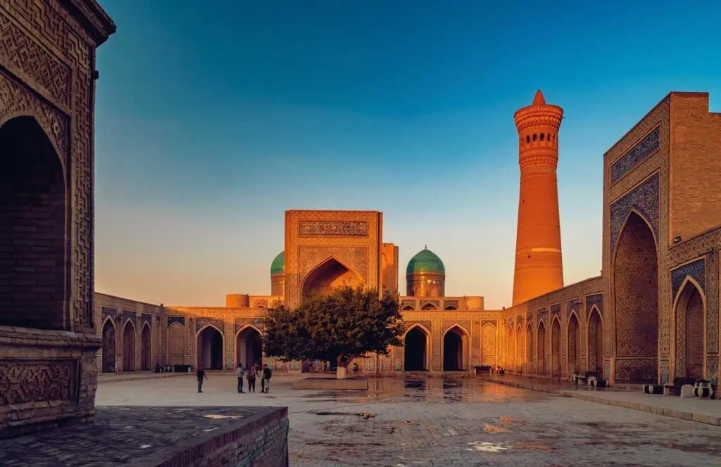 Kalyan Minaret and mosque courtyard in Bukhara glowing at golden hour