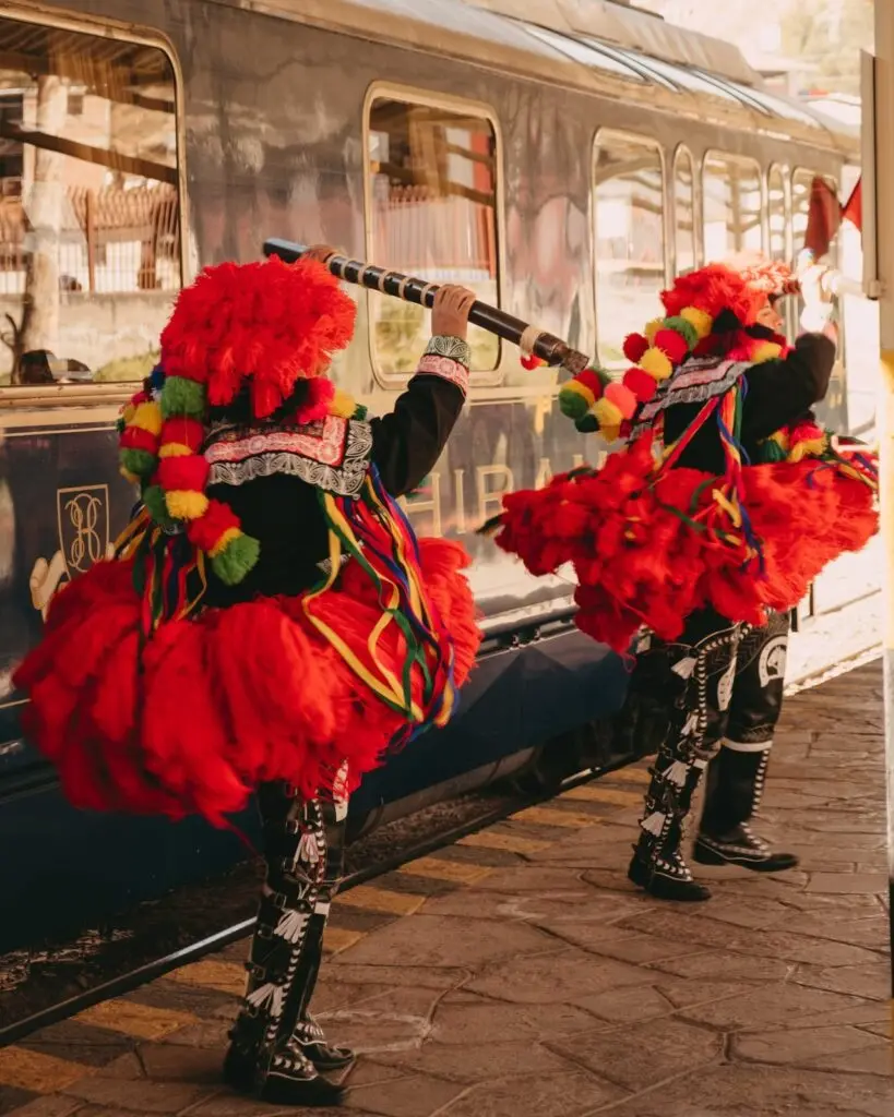 Andean dancers welcoming guests on the platform