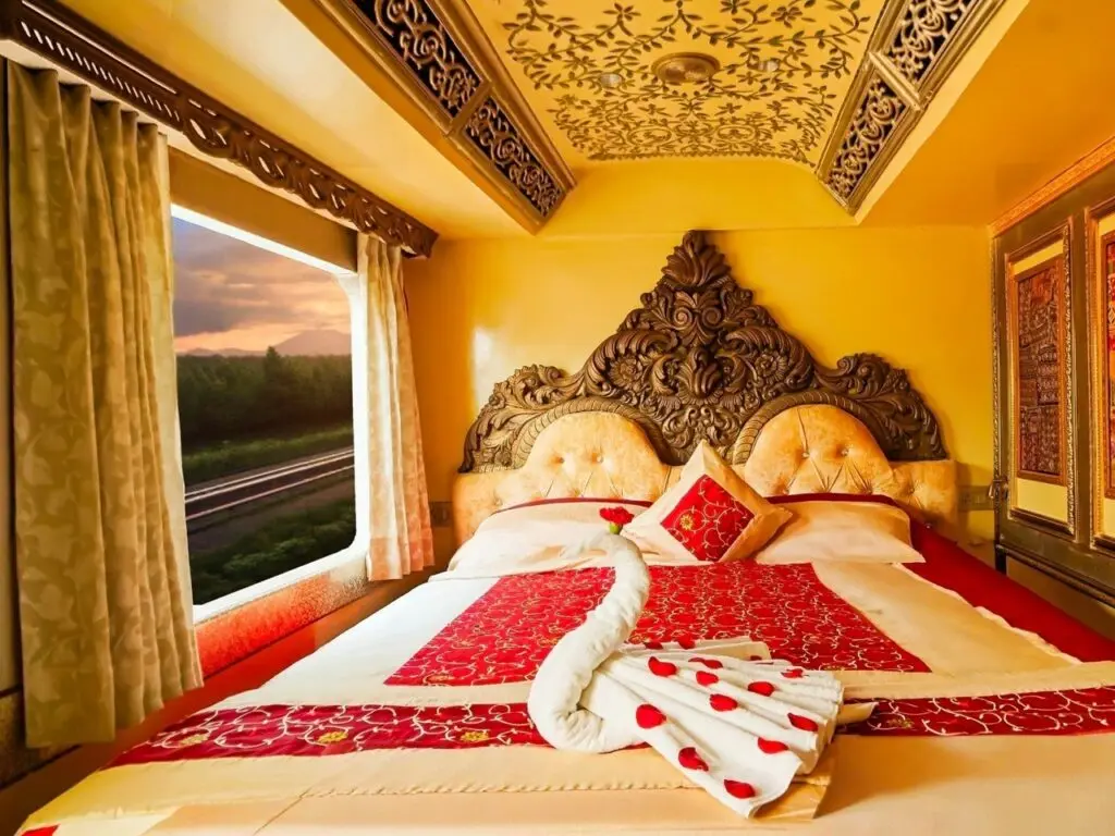 Suite bedroom with carved headboard on the Palace on Wheels